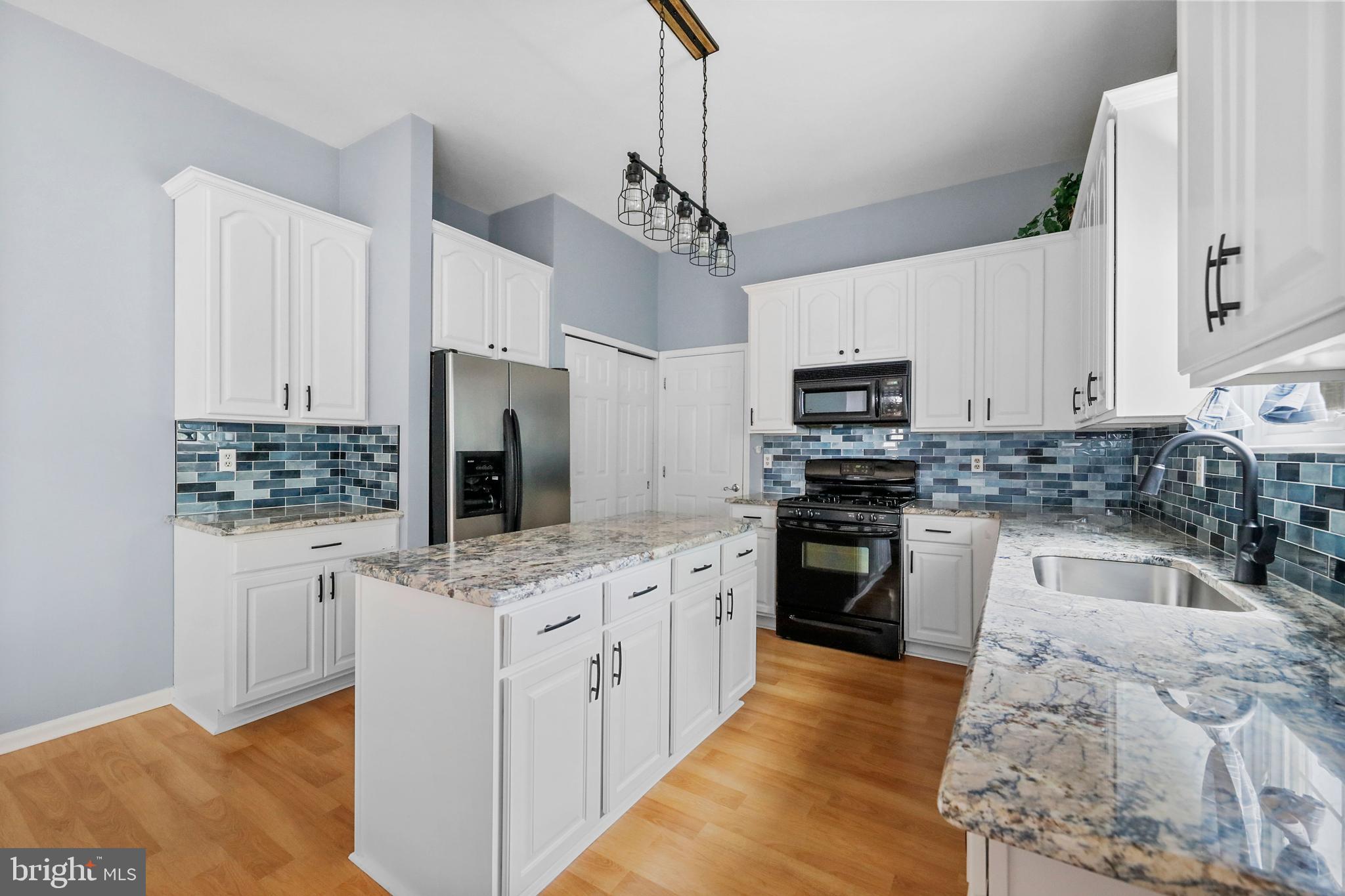 19 Pear Tree Place Sewell, NJ 08080 - Photo 12 of 47 a kitchen with stainless steel appliances kitchen island granite countertop a stove sink and cabinets