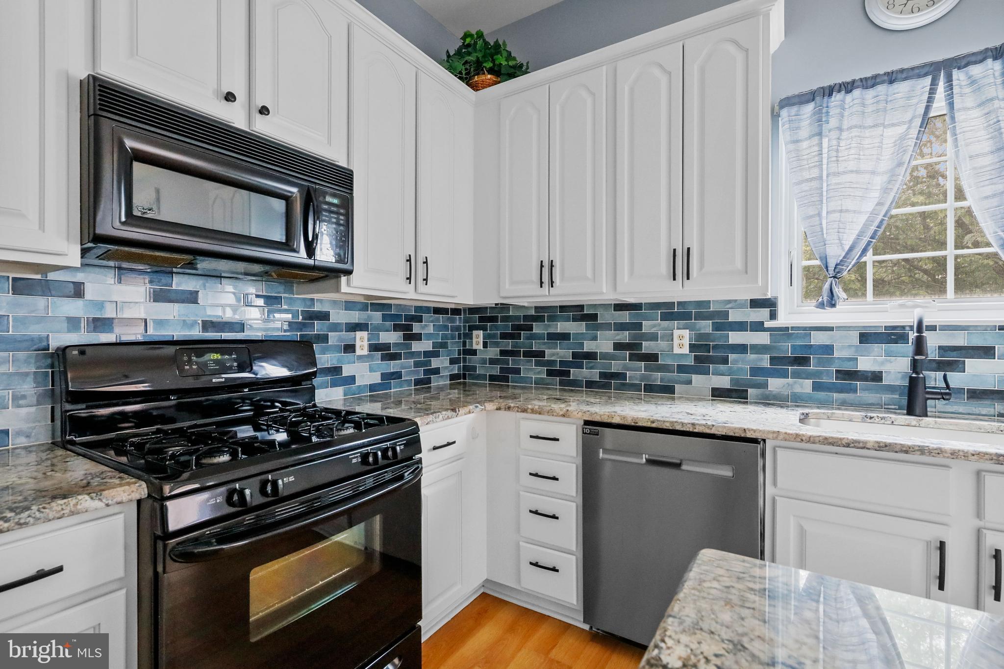 19 Pear Tree Place Sewell, NJ 08080 - Photo 14 of 47 a kitchen with cabinets appliances a sink and a window