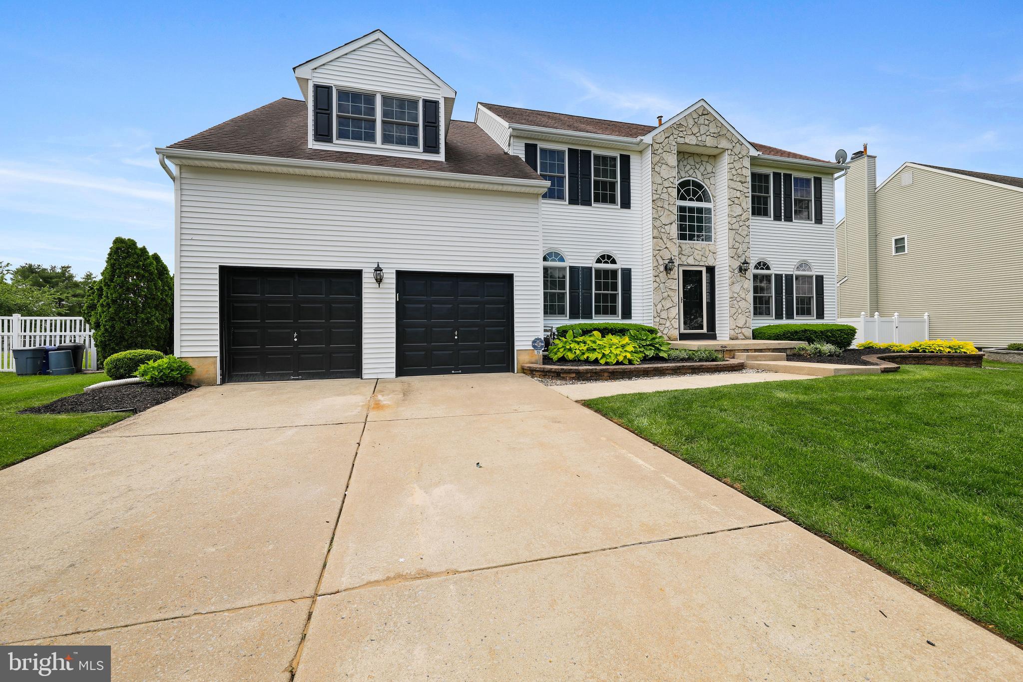 19 Pear Tree Place Sewell, NJ 08080 - Photo 3 of 47 a front view of a house with a yard and garage