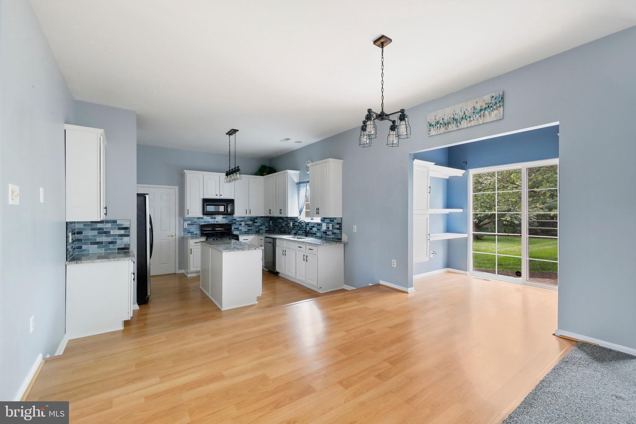 19 Pear Tree Place Sewell, NJ 08080 - Photo 9 of 47 a kitchen with stainless steel appliances kitchen island granite countertop a refrigerator a stove a sink dishwasher a oven with white cabinets and wooden floor