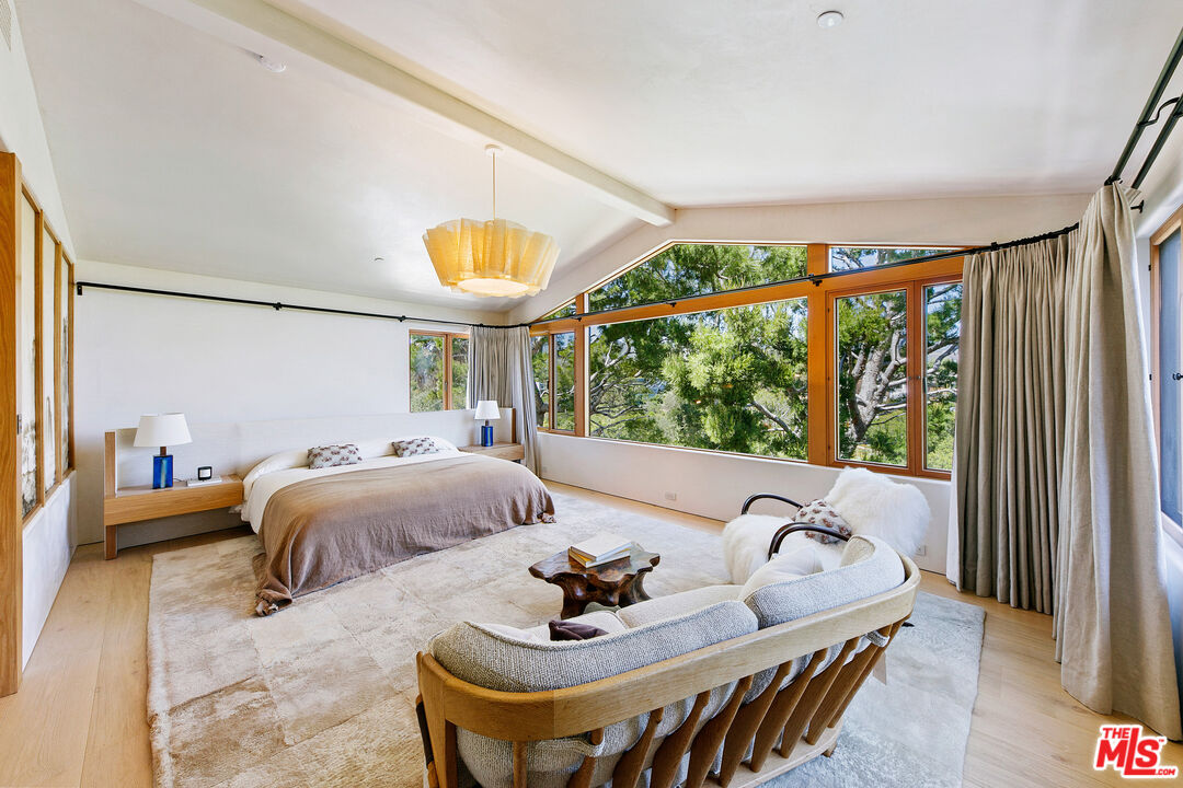 6902 Wildlife Road Malibu, CA 90265 - Photo 16 of 41 a bed sitting in a bedroom next to a window