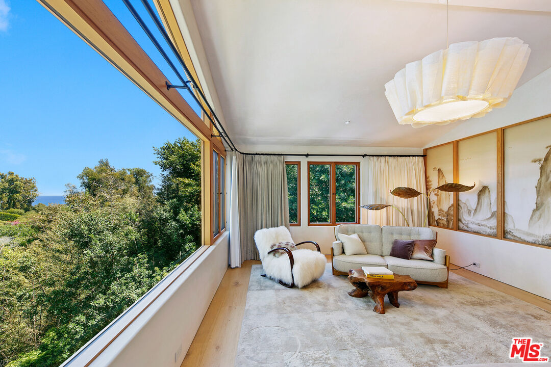 6902 Wildlife Road Malibu, CA 90265 - Photo 19 of 41 a balcony with furniture and a large window