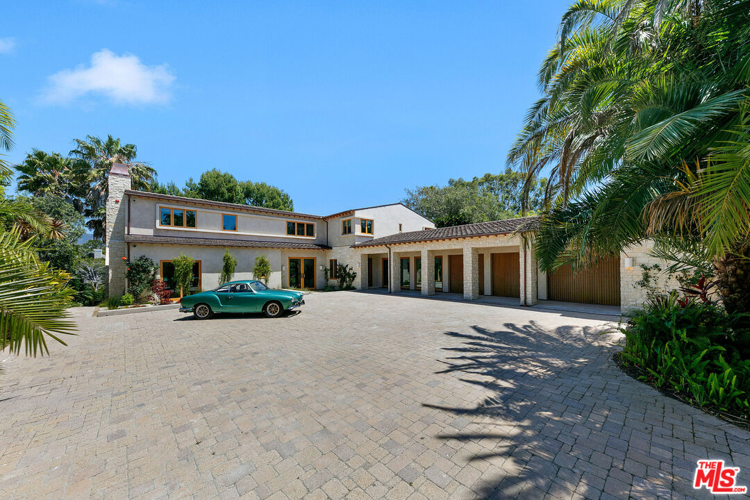 6902 Wildlife Road Malibu, CA 90265 - Photo 2 of 41 a front view of a house with a yard and potted plants