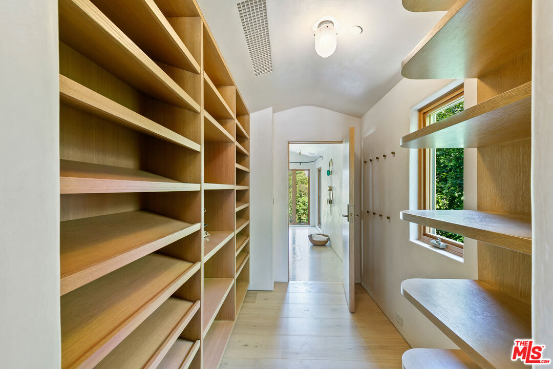 6902 Wildlife Road Malibu, CA 90265 - Photo 23 of 41 a view of walk in closet with empty racks