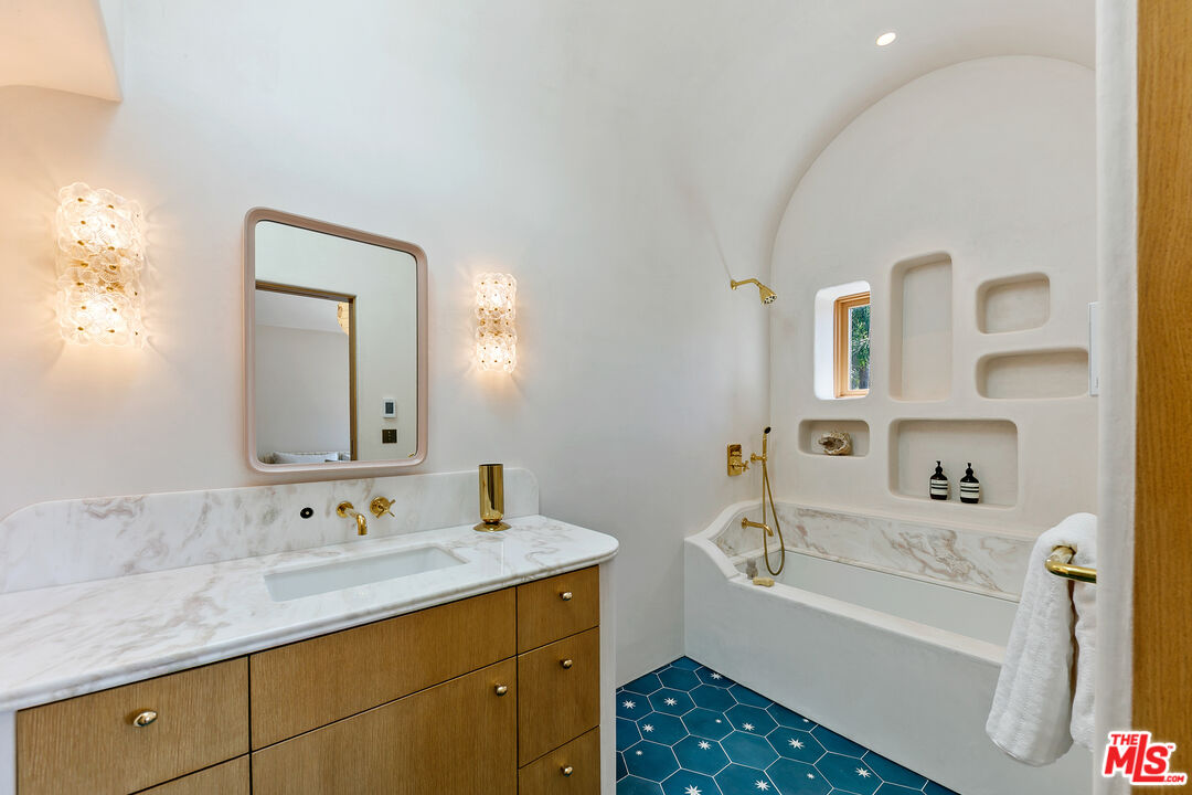 6902 Wildlife Road Malibu, CA 90265 - Photo 25 of 41 a bathroom with a tub sink and mirror