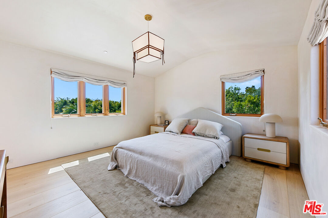 6902 Wildlife Road Malibu, CA 90265 - Photo 26 of 41 a bedroom with a bed and a window