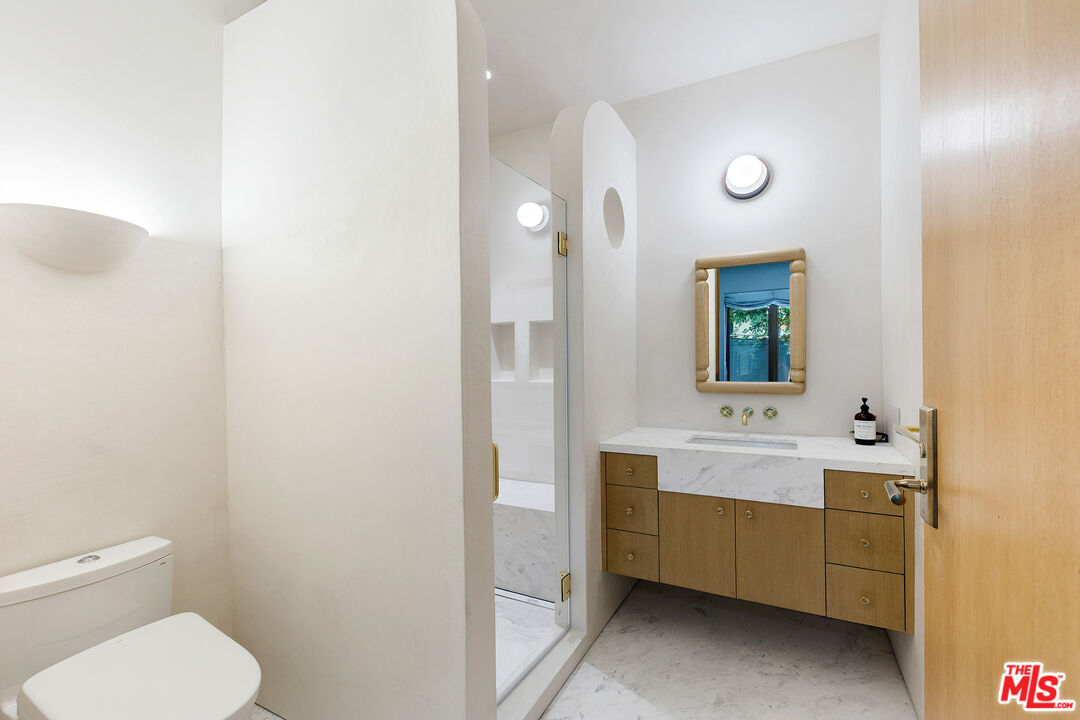 6902 Wildlife Road Malibu, CA 90265 - Photo 29 of 41 a bathroom with a toilet sink and mirror