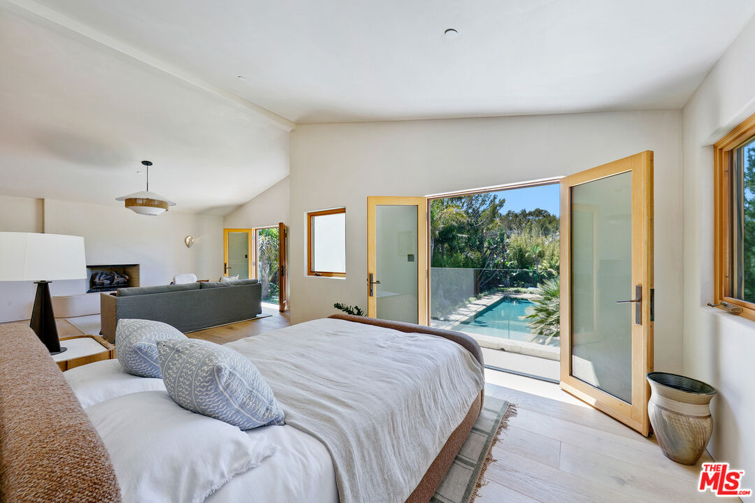 6902 Wildlife Road Malibu, CA 90265 - Photo 34 of 41 a bedroom with a large bed and a large window