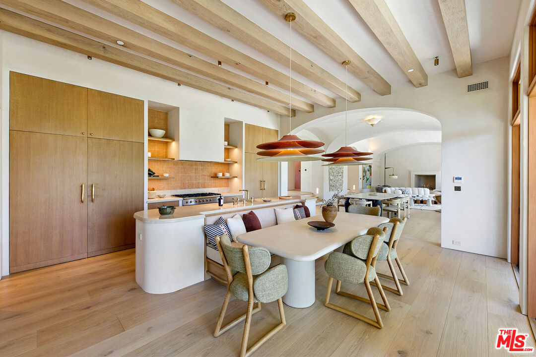 6902 Wildlife Road Malibu, CA 90265 - Photo 9 of 41 a view of a dining room with furniture and wooden floor