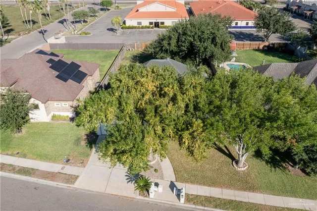 an aerial view of a house with yard swimming pool and outdoor seating
