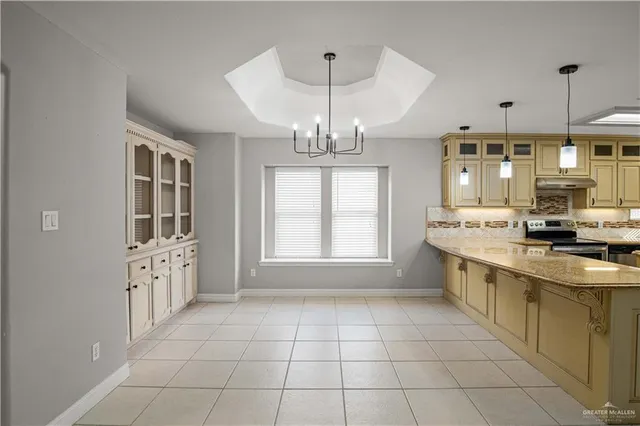 a large kitchen with a large window and stainless steel appliances