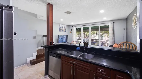 a kitchen with a sink and a large window