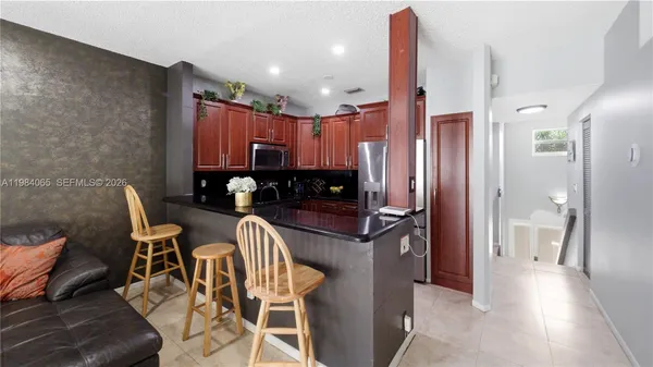 a kitchen with a table and chairs
