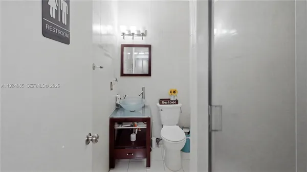 a bathroom with a toilet a sink and mirror