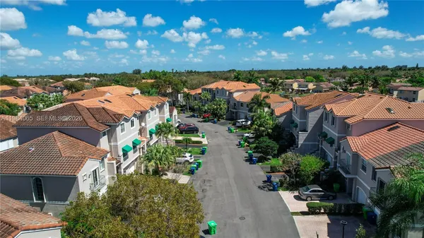 an aerial view of residential houses with outdoor space