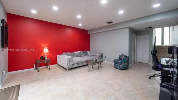 a living room with furniture and a flat screen tv