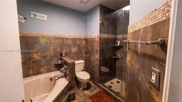 a bathroom with a toilet and a shower