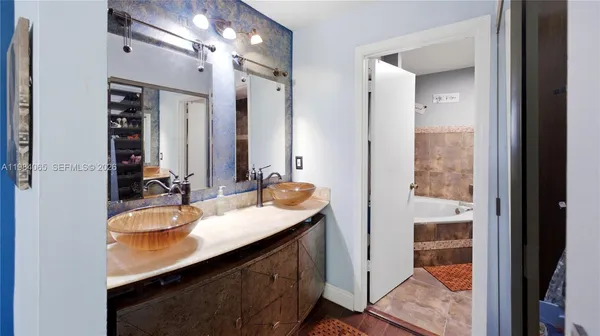 a bathroom with a double vanity sink a vanity and a mirror