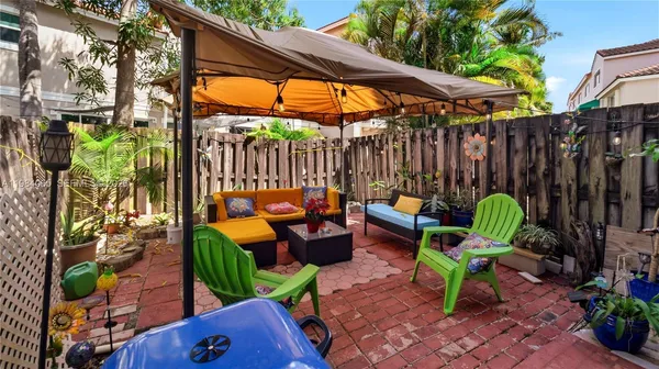 a view of a chairs and table in backyard