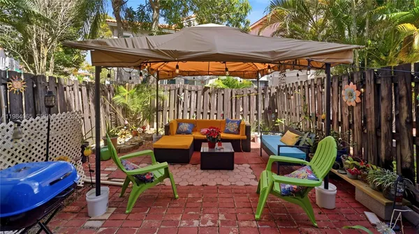 a backyard of a house with barbeque oven table and chairs