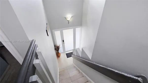 a view of entryway with stairs and wooden floor