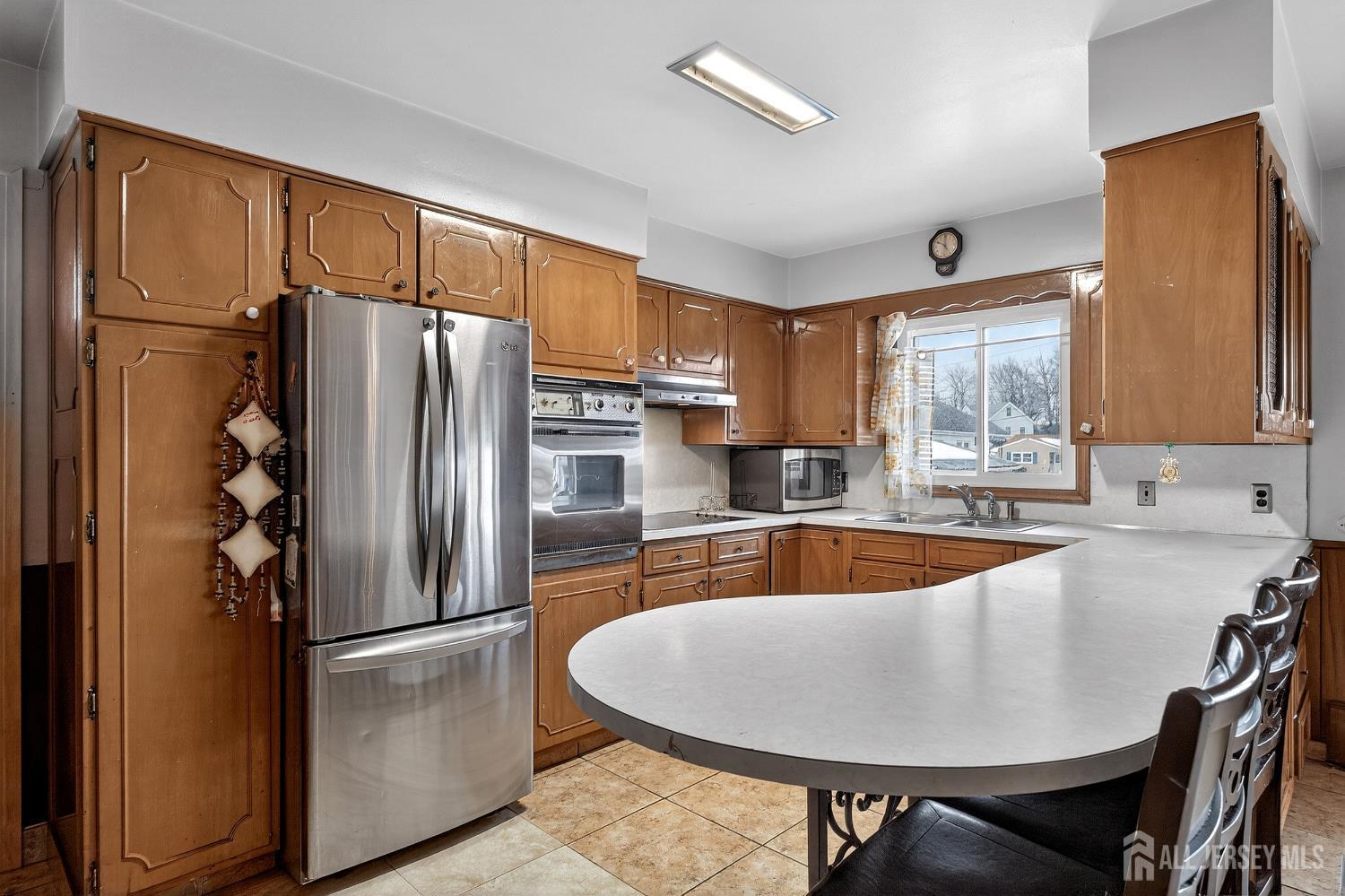 6 East 2nd Street Port Reading, NJ 07064 - Photo 5 of 40 a kitchen with stainless steel appliances granite countertop a refrigerator a sink and a refrigerator