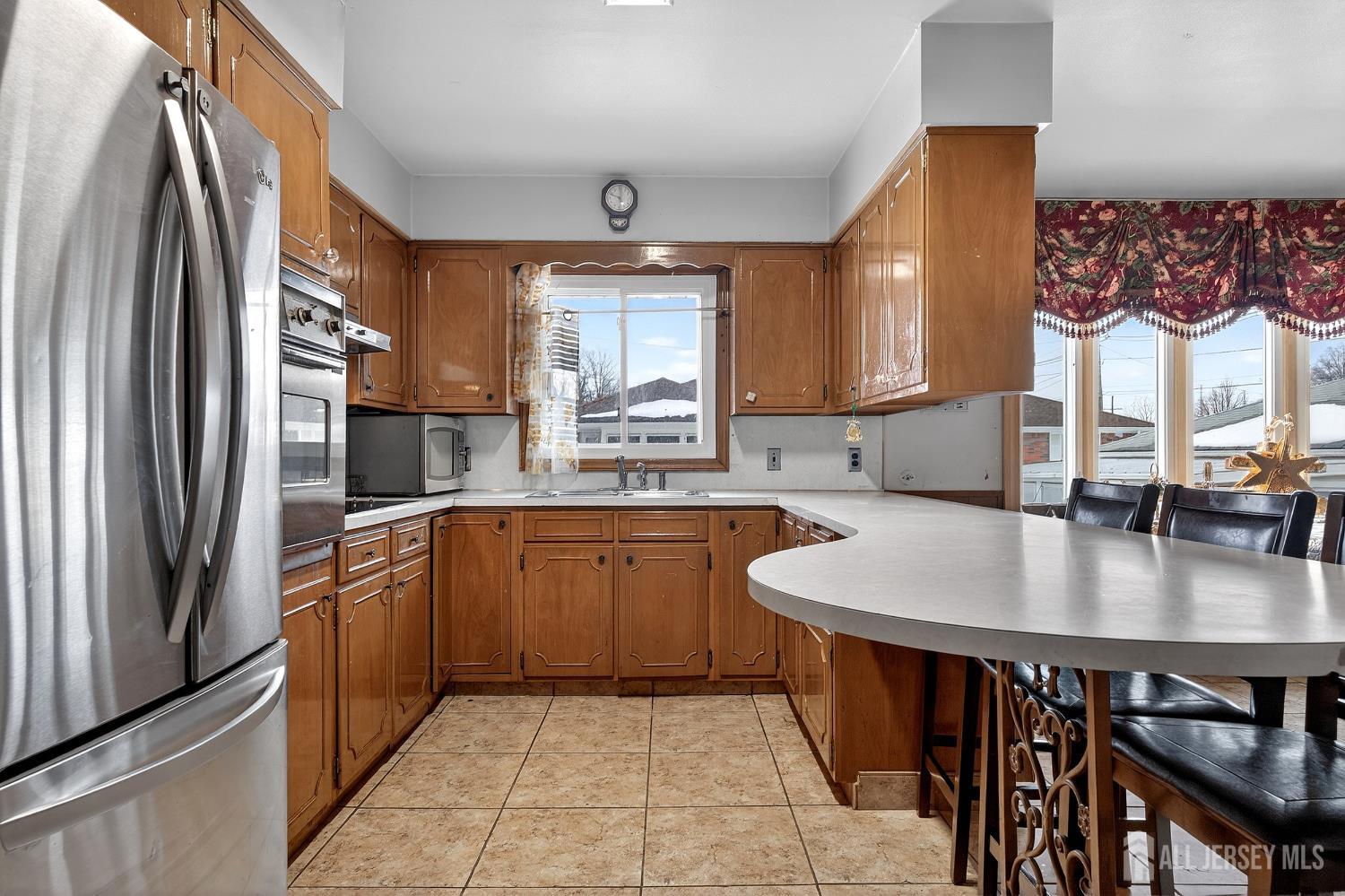 6 East 2nd Street Port Reading, NJ 07064 - Photo 6 of 40 a kitchen with stainless steel appliances granite countertop a sink a stove and a refrigerator