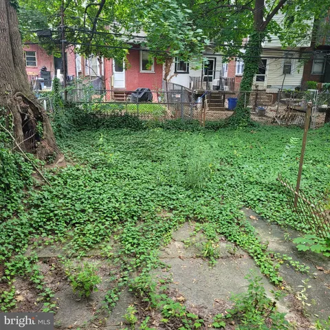 a backyard of a house with yard and outdoor seating