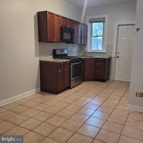 a kitchen with stainless steel appliances a sink and a stove top oven