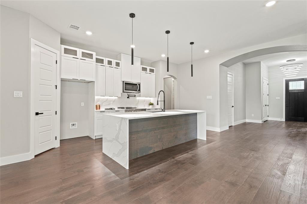 38093 Misty Ridge Drive Whitney, TX 76692 - Photo 7 of 25 a view of kitchen with kitchen island white cabinets and stainless steel appliances