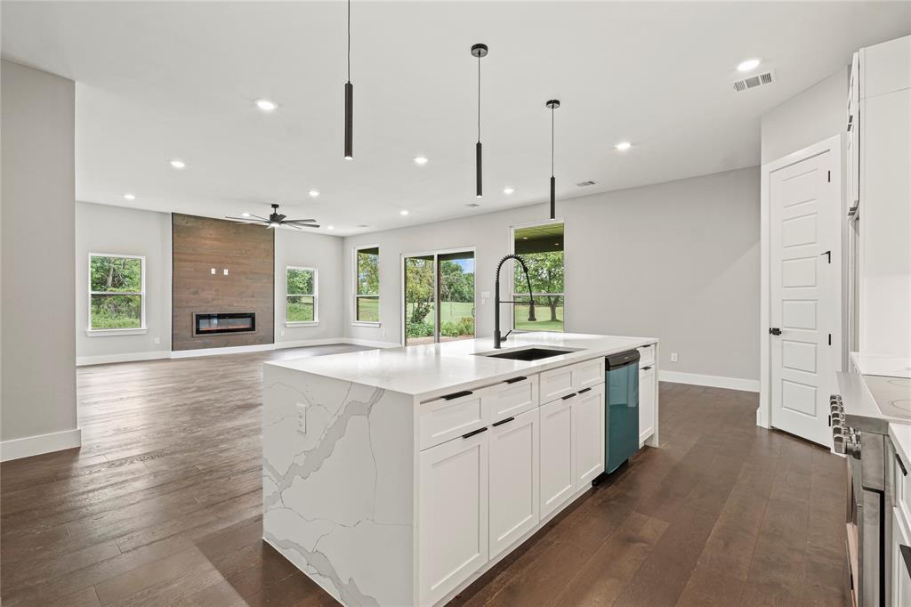 38093 Misty Ridge Drive Whitney, TX 76692 - Photo 9 of 25 a large kitchen with stainless steel appliances kitchen island a large island in the center