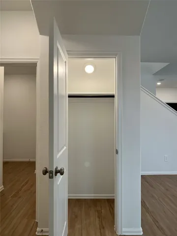 an empty room with wooden floor