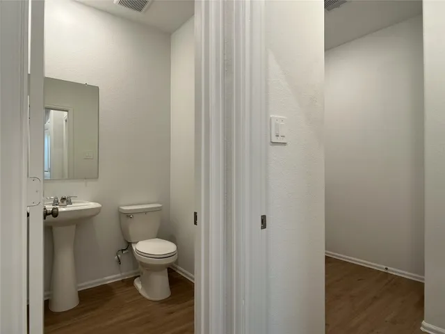 a bathroom with a toilet a sink and view