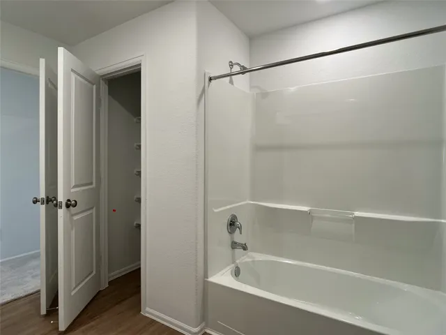 a bathroom with a shower and a bath tub