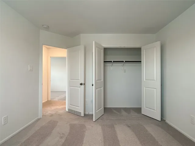 a view of an empty room and closet area