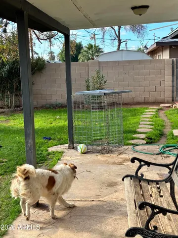 a backyard of a house with a garden and outdoor seating