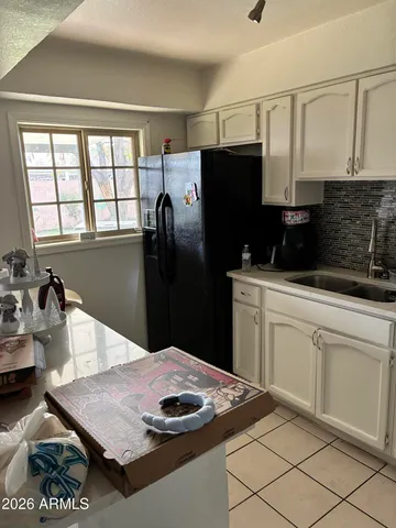 a kitchen with stainless steel appliances granite countertop a sink refrigerator and microwave