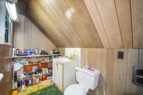 a utility room with dryer washer and a view of living room