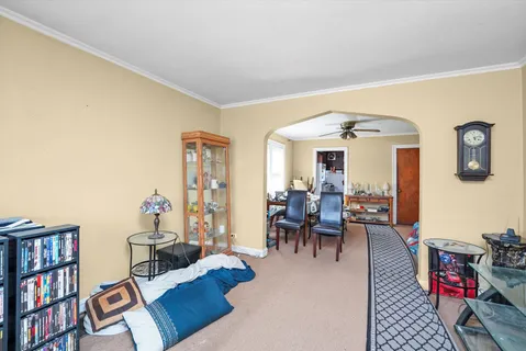 a living room with furniture and a book shelf
