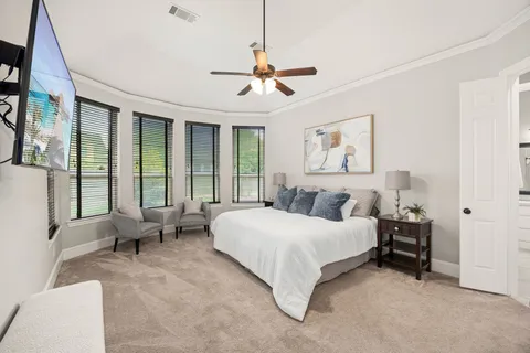 a view of a living room with furniture and flat screen tv
