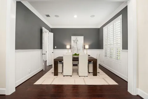 a view of a dining room with furniture kitchen and wooden floor