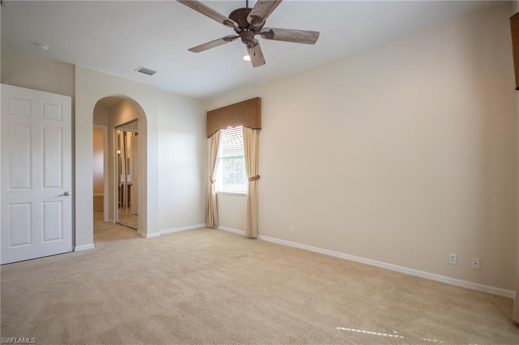 9337 Springview Loop Estero, FL 33928 - Photo 20 of 25 an empty room with windows and ceiling fan