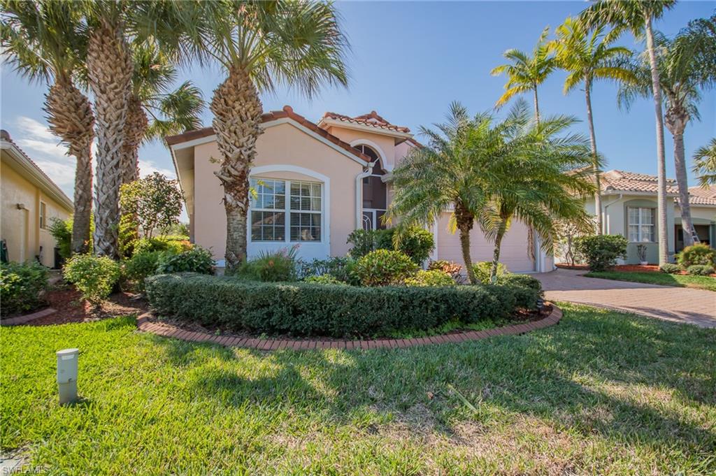 9337 Springview Loop Estero, FL 33928 - Photo 2 of 25 a front view of house and yard with green space