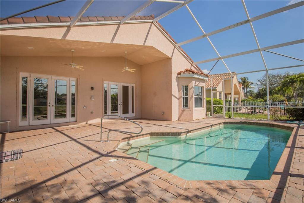 9337 Springview Loop Estero, FL 33928 - Photo 23 of 25 a view of a backyard with a patio and a yard