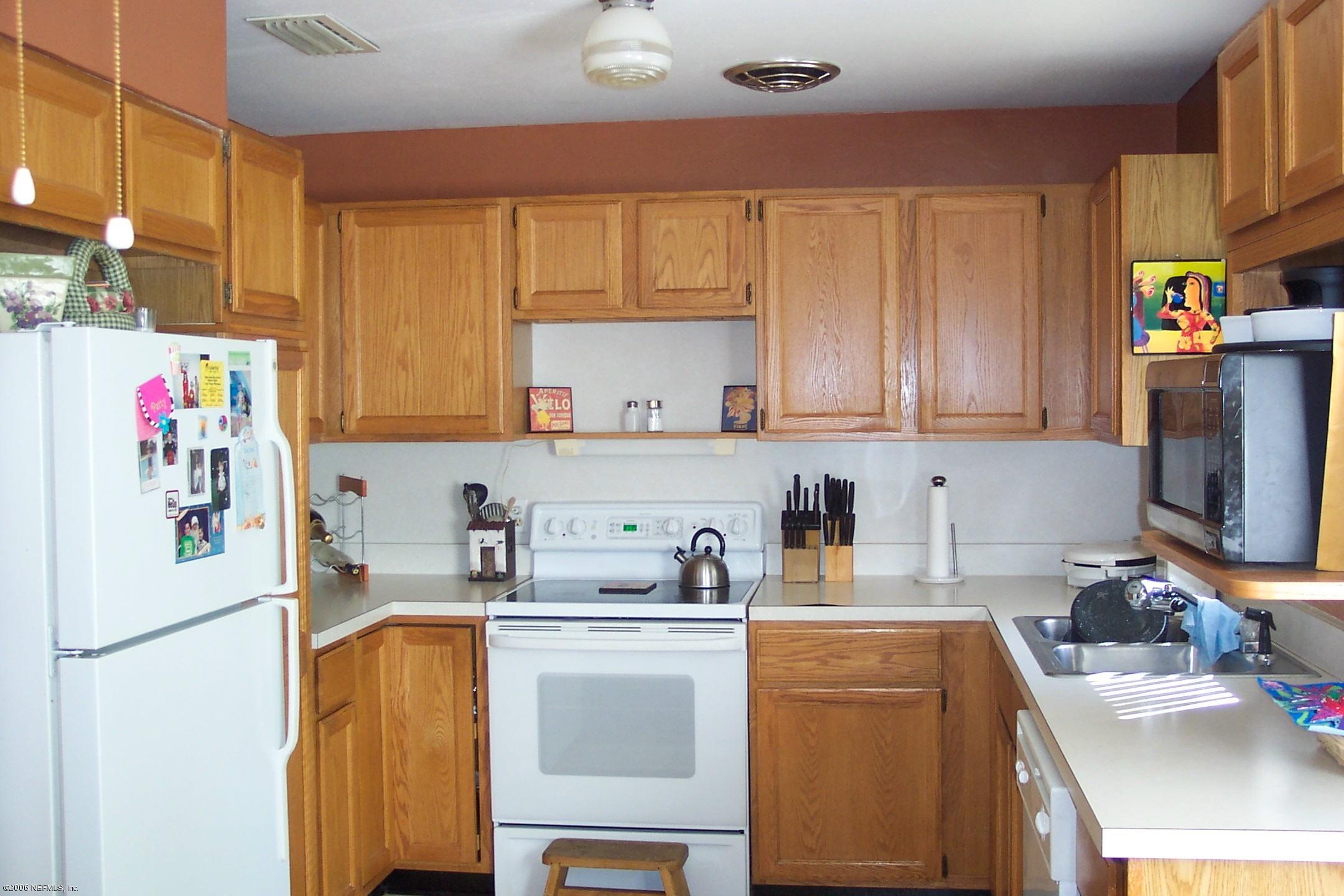 2806 Randy Road Jacksonville, FL 32216 - Photo 5 of 10 a kitchen with a refrigerator sink and cabinets