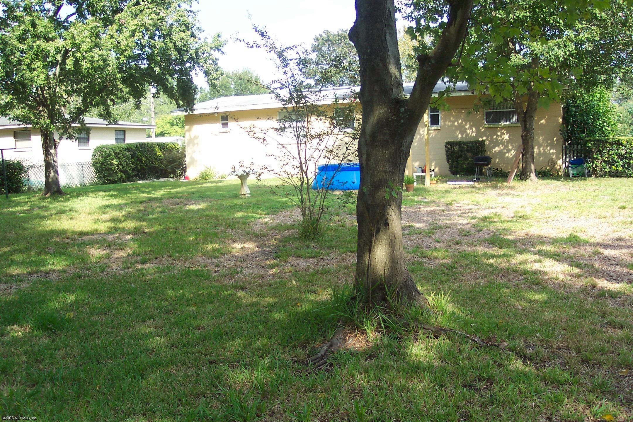 2806 Randy Road Jacksonville, FL 32216 - Photo 10 of 10 a view of a yard with plants and large trees