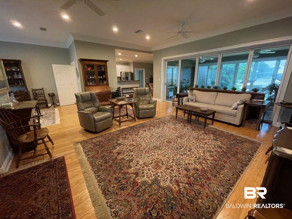 6426 East Quarry Drive Elberta, AL 36530 - Photo 2 of 19 Living room featuring crown molding, ceiling fan, and light hardwood / wood-style floors