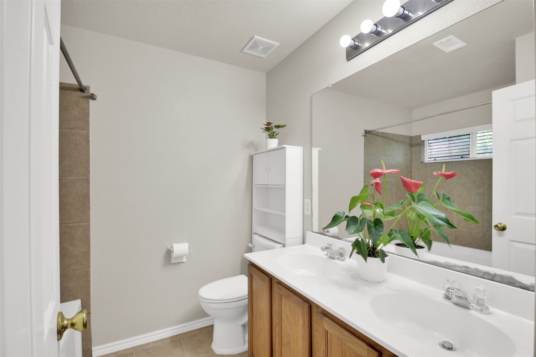 73 Verde Ranch Loop Leander, TX 78641 - Photo 18 of 29 Bathroom featuring toilet, tile patterned floors, a sink, and a shower