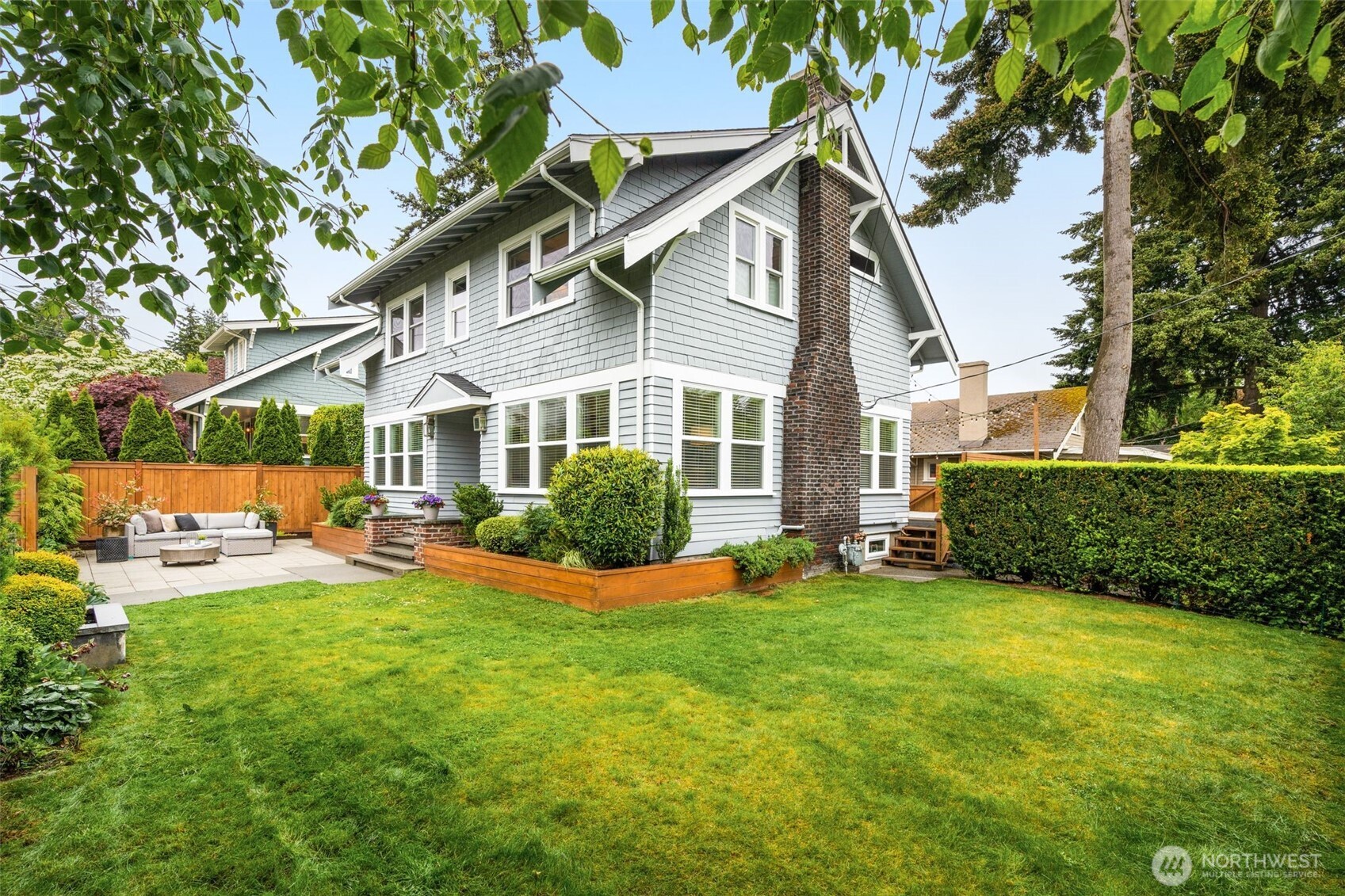 170 Lynn Street Seattle, WA 98109 - Photo 32 of 40 a view of a house with a yard and sitting area