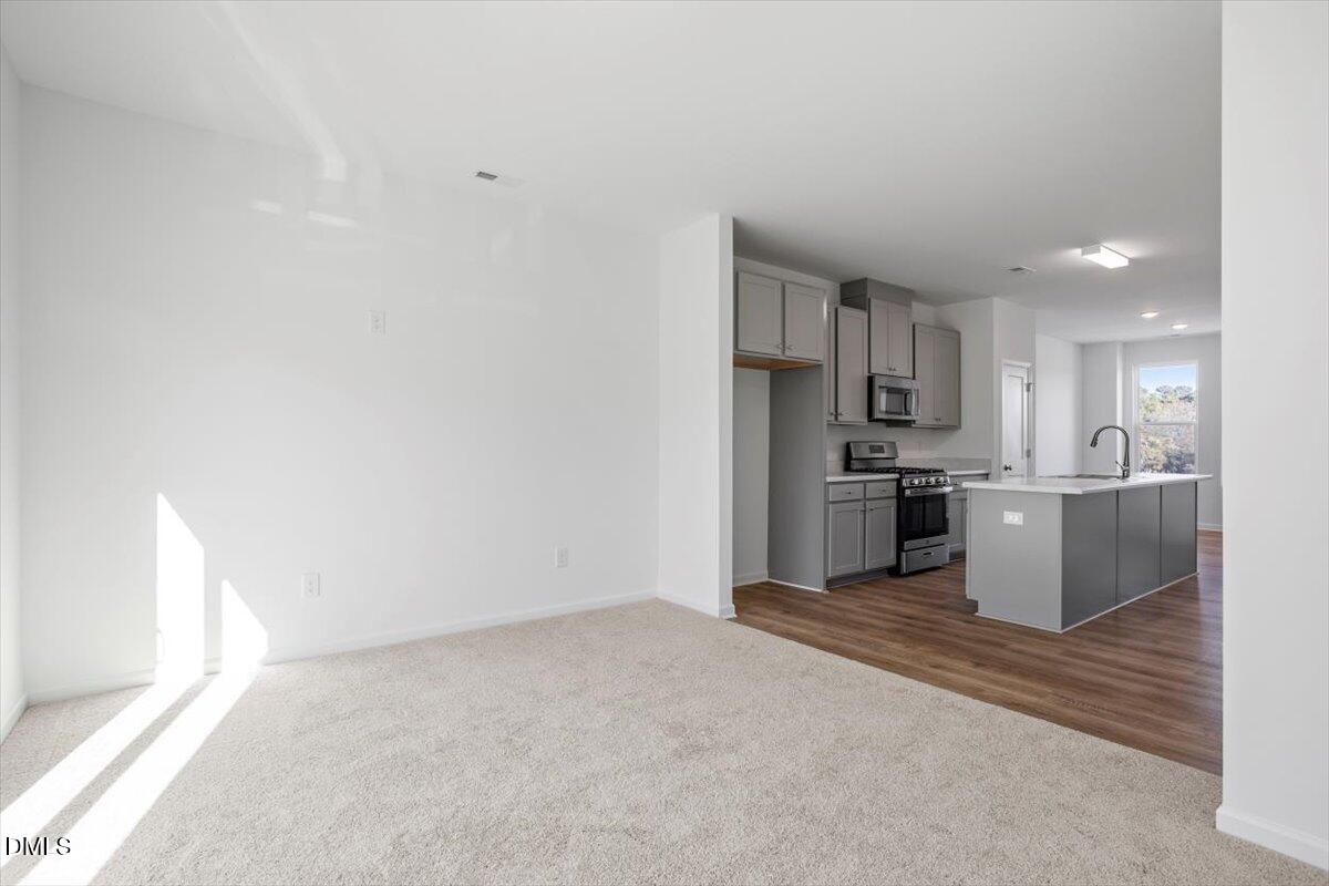 443 North Fisher Street Raleigh, NC 27610 - Photo 11 of 33 a large white kitchen with cabinets